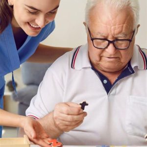 caregiver with client doing a puzzle