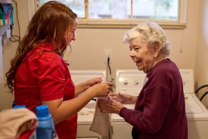 caregiver helping client with laundry landscape (1)
