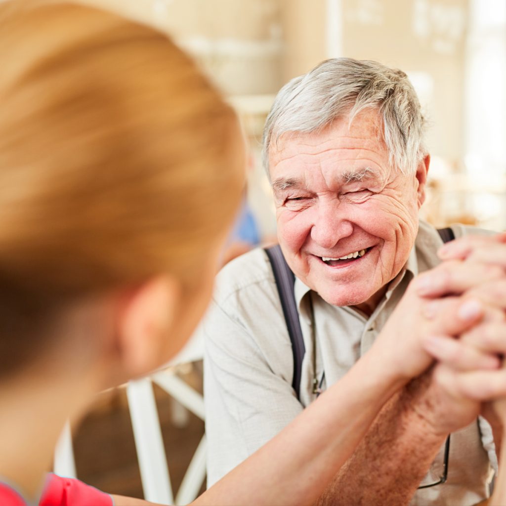 rhythms home care caregiver laughing with senior male client