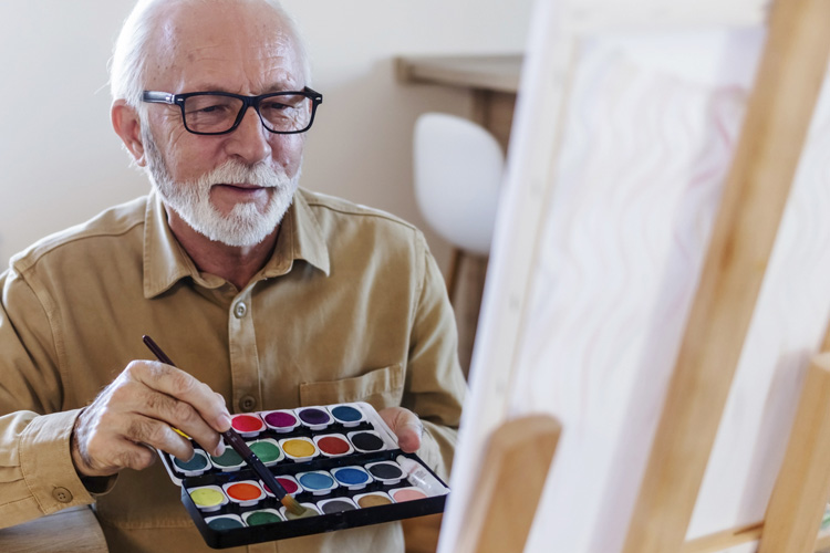 rhythms home care senior man painting at an easel rhythms home care senior man painting at an easel