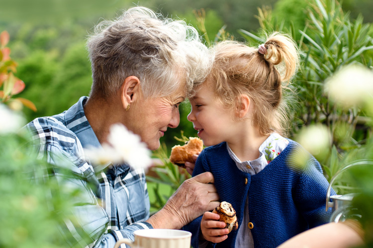 rhythms home care senior woman with granddaughter eating pastry outdoors rhythms home care senior woman with granddaughter eating pastry outdoors