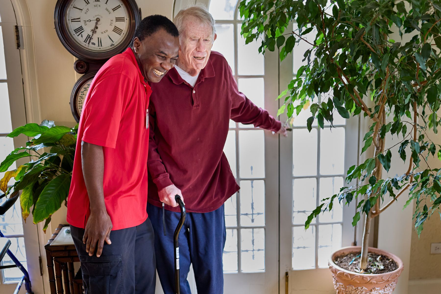 caregiver helping client walk landscape (1)