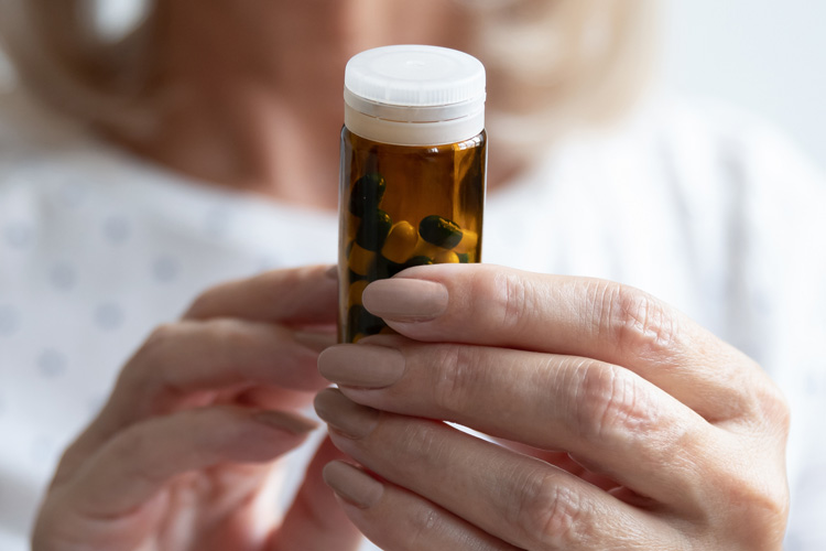 rhythms home care closeup of senior womans hands holding prescription bottle