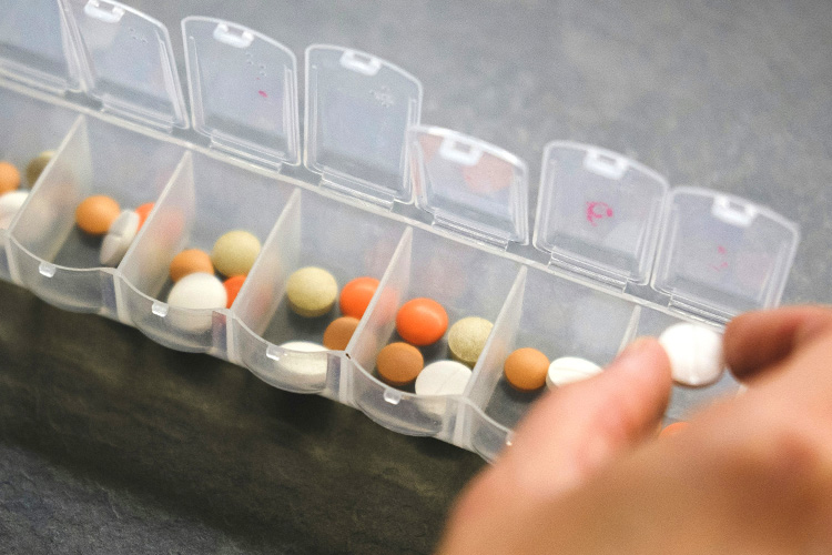 rhythms home care putting pills in pill container