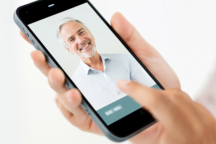rhythms home care hand with iphone facetime rhythms home care hand with iphone facetime